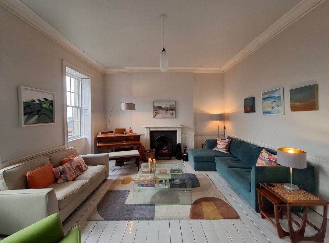 A room filled with luxurious furniture and artwork hanging on the walls